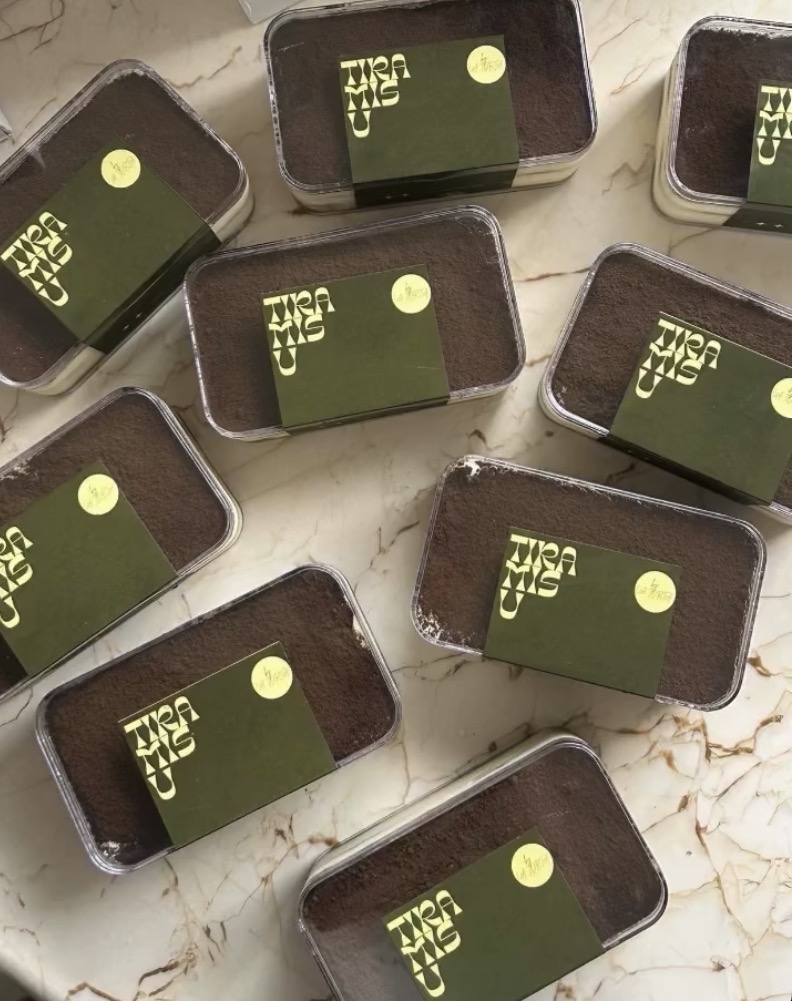 Tiramisu tubs with olive green La Torta sleeves on marble